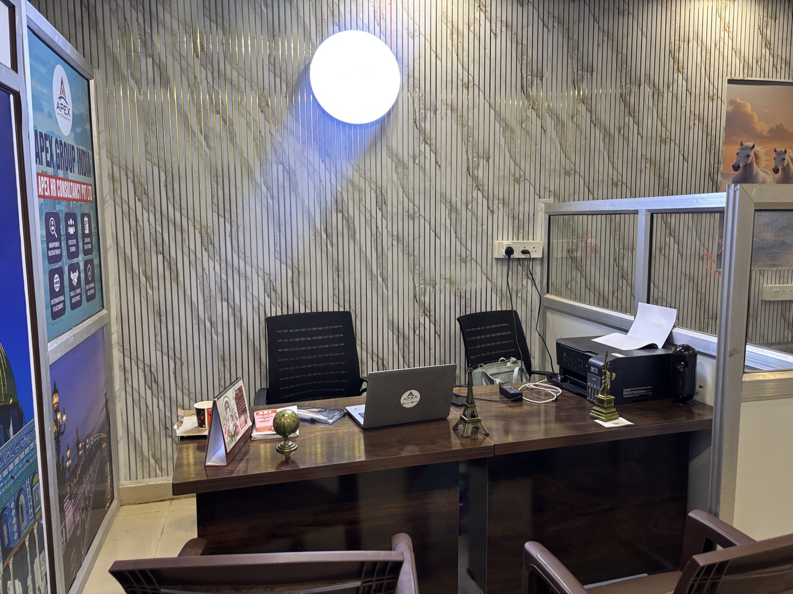 Consultant workstation with laptop and printer inside the Apex HR office