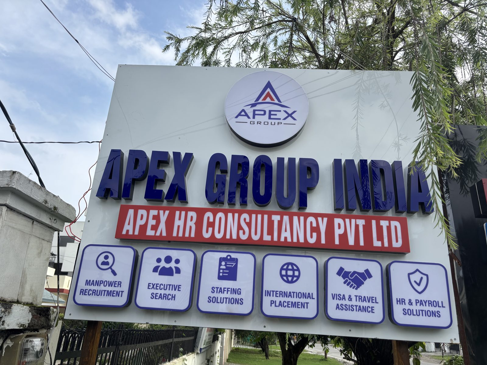 Apex Group India signage board listing recruitment services at the Dehradun office